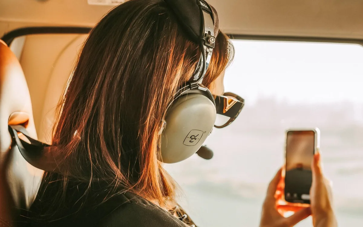 A passenger photographing Dubai through a helicopter window