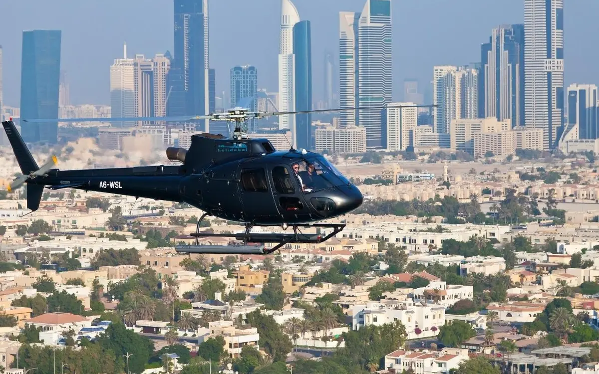 A helicopter over the sea near the Burj Al Arab in Dubai