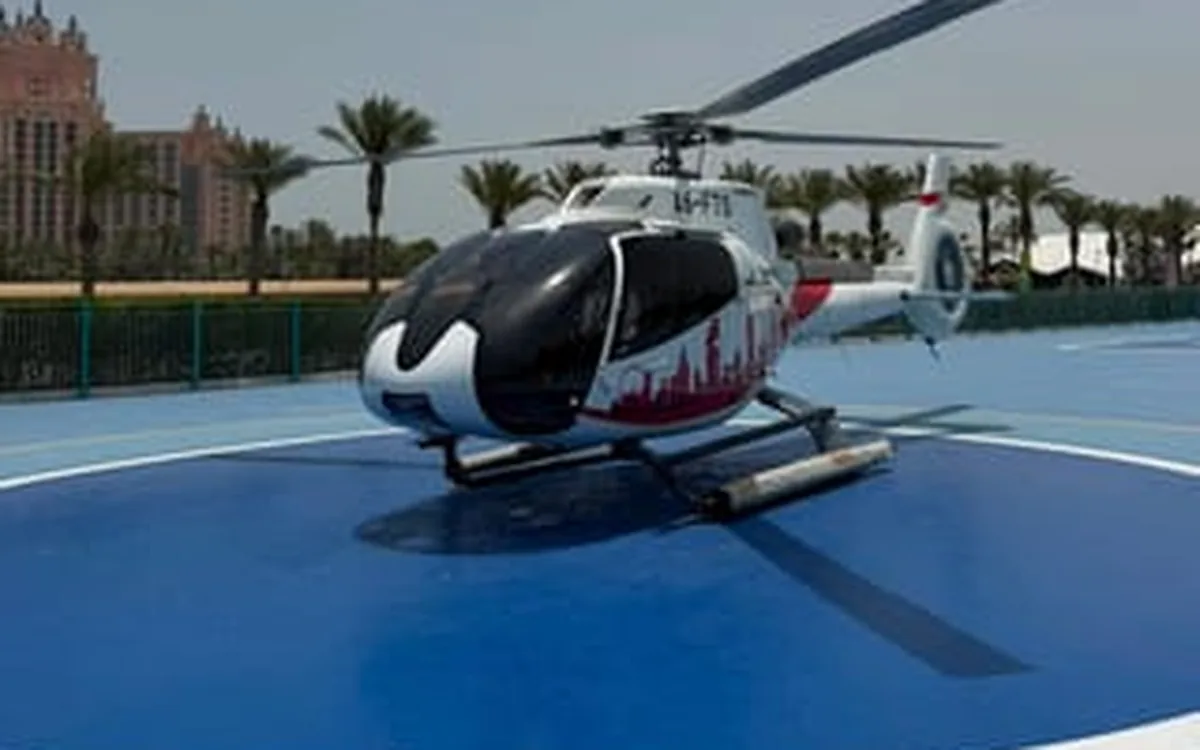 A sightseeing helicopter on a helipad in Dubai