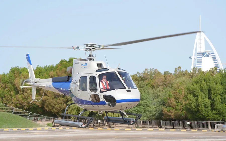 A private helicopter waiting on a helipad in Dubai
